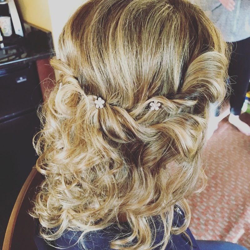 picture of client with a wedding updo, pulled back from the front and curled