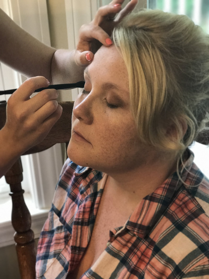 Picture of client getting her makeup done.