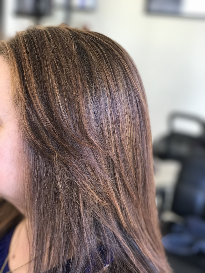 Picture of client with soft brown hair that had highlights added in