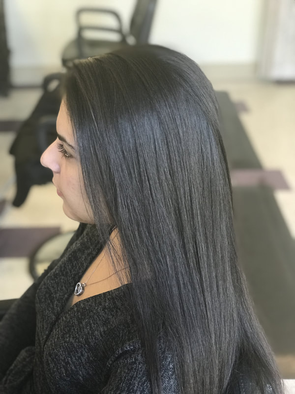 Picture of client with long dark brown hair straightened